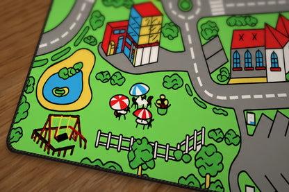 Close-up of the mat corner showing the stitched black edge and the park, pond and playground in the print