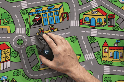 Hand gliding a black gaming mouse along the printed roads of the Childhood Mat Classic City desk mat